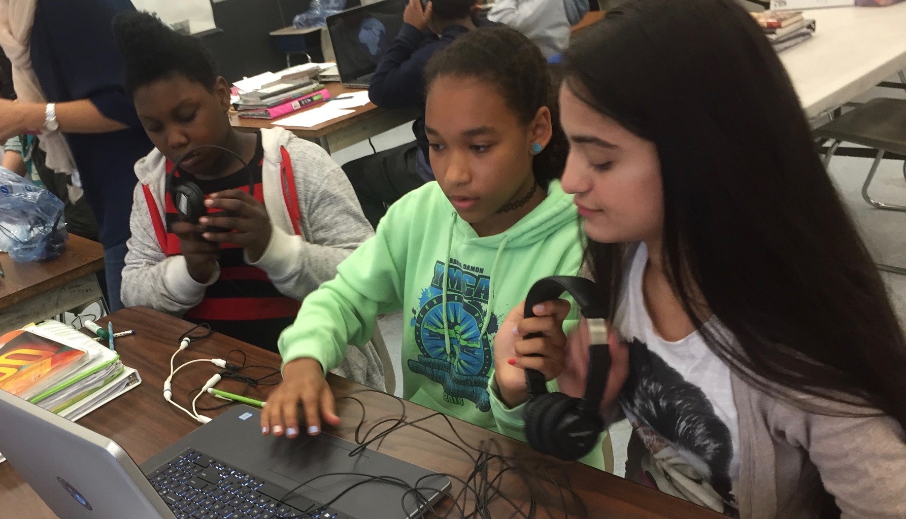 three students in a classroom